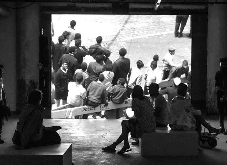 A group of people watch a film