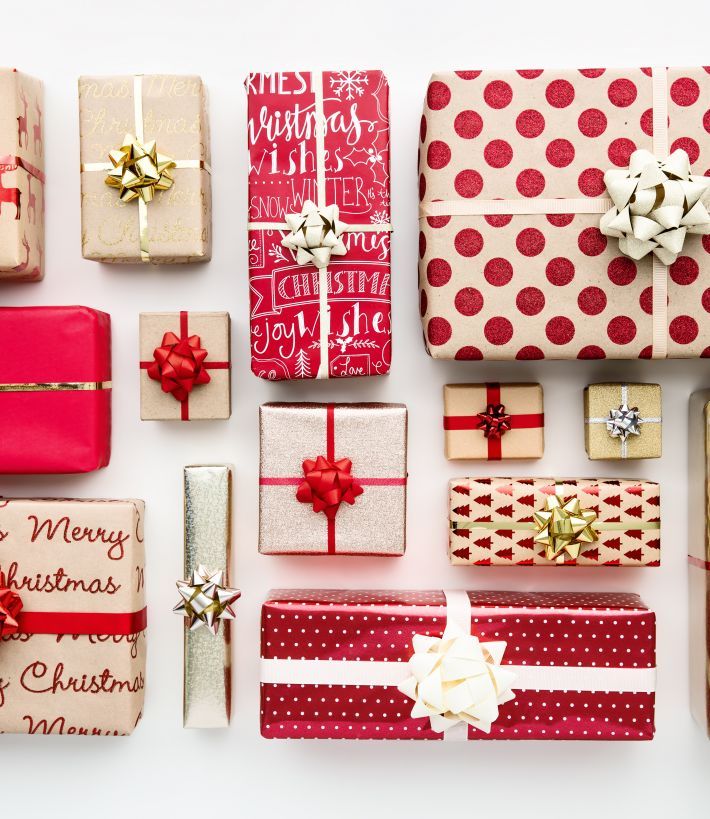a photo of a number of different sized present boxes lined up all wrapped in designs of red and white paper