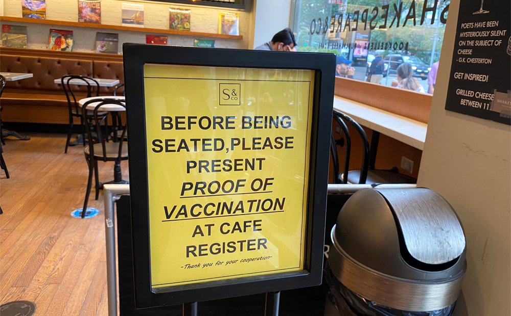 LSBID Staff photo of vaccine requirement signage at Shakespeare & Co. Cafe's indoor dining area