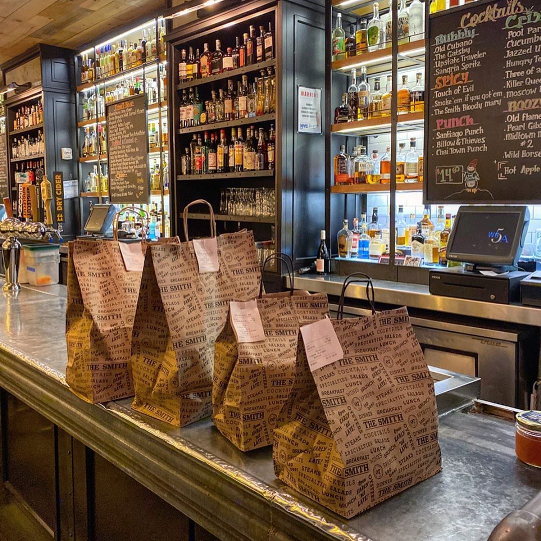 takeout bags on the counter inside of The Smith